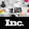 A graphic designer working at their desk, with many tools on it. Below, the "Inc." logo in white on black.
